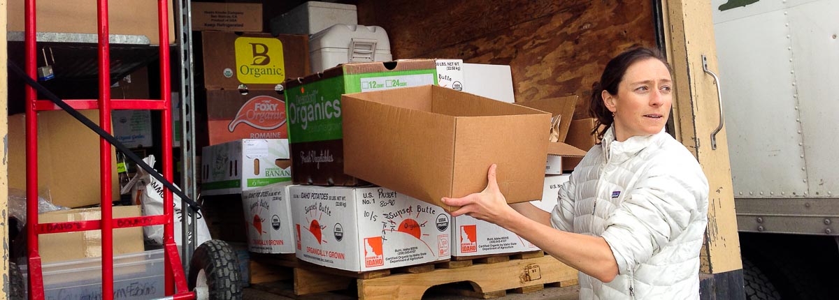 woman offloading vegetable from truck