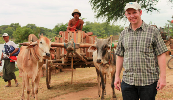 Brian Flanagan in front of a mango cart coming in from the field for distribution and processing