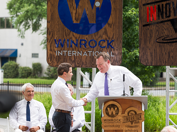 Winrock President and CEO Rodney Ferguson congratulates Innovation Hub founder Warwick Sabin upon his being named Winrock’s new senior director of U.S. programs.